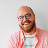 A happy man poses for a casual headshot.