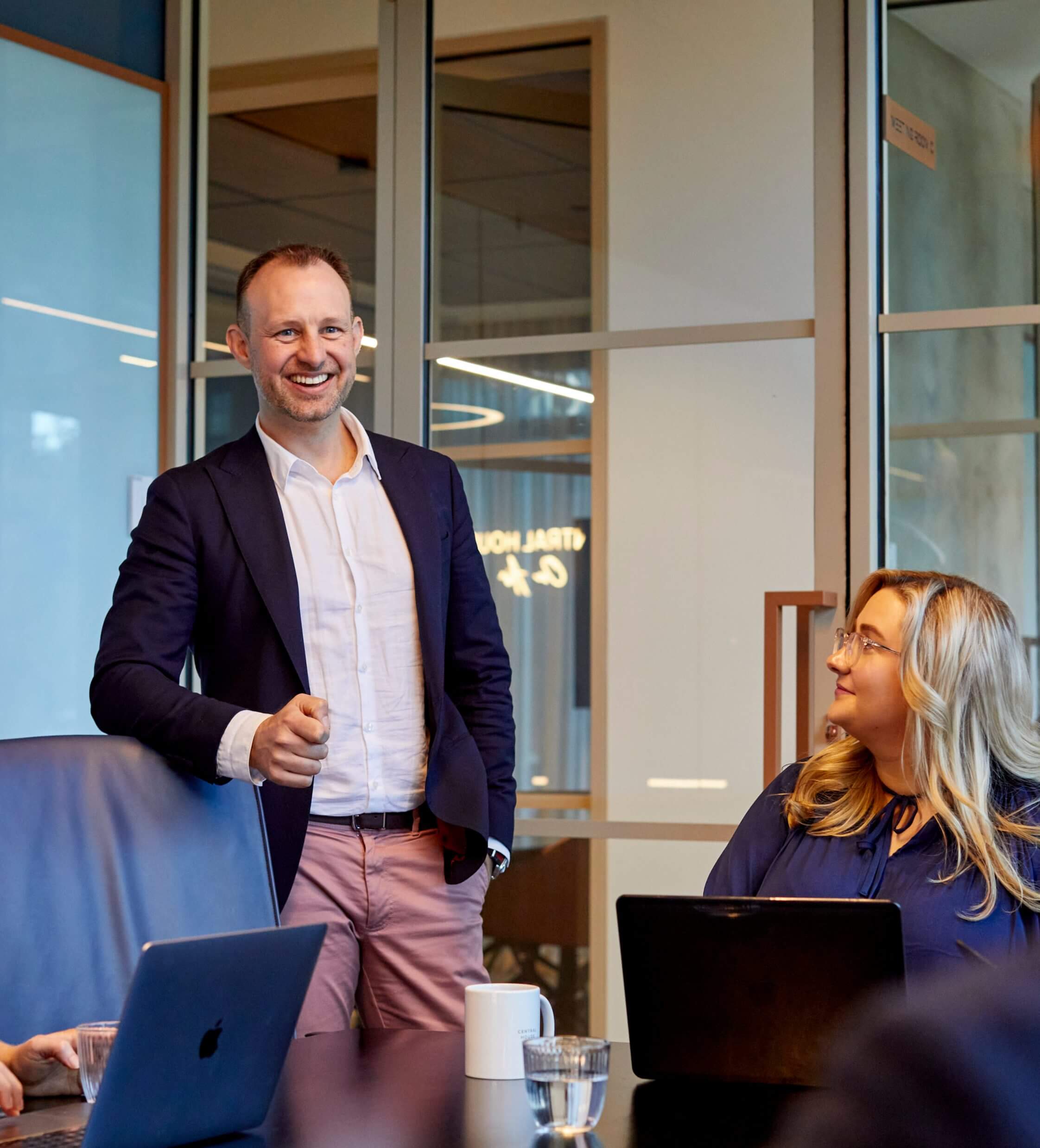 Burch and Co's Director smiling while presenting to the team.